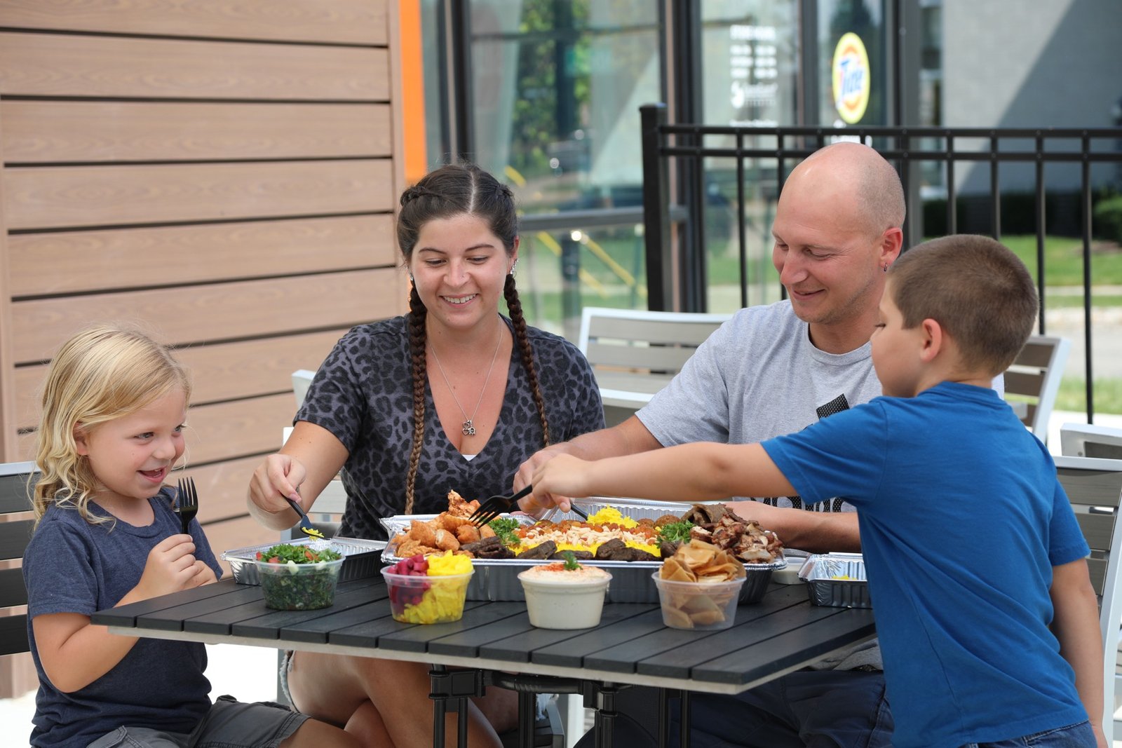 Family enjoying a meal at Pita Way
